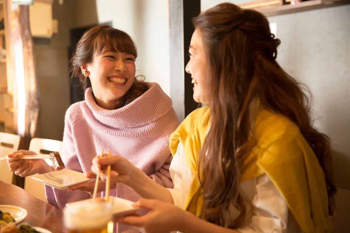 お箸を手に、笑顔で食事をする二人